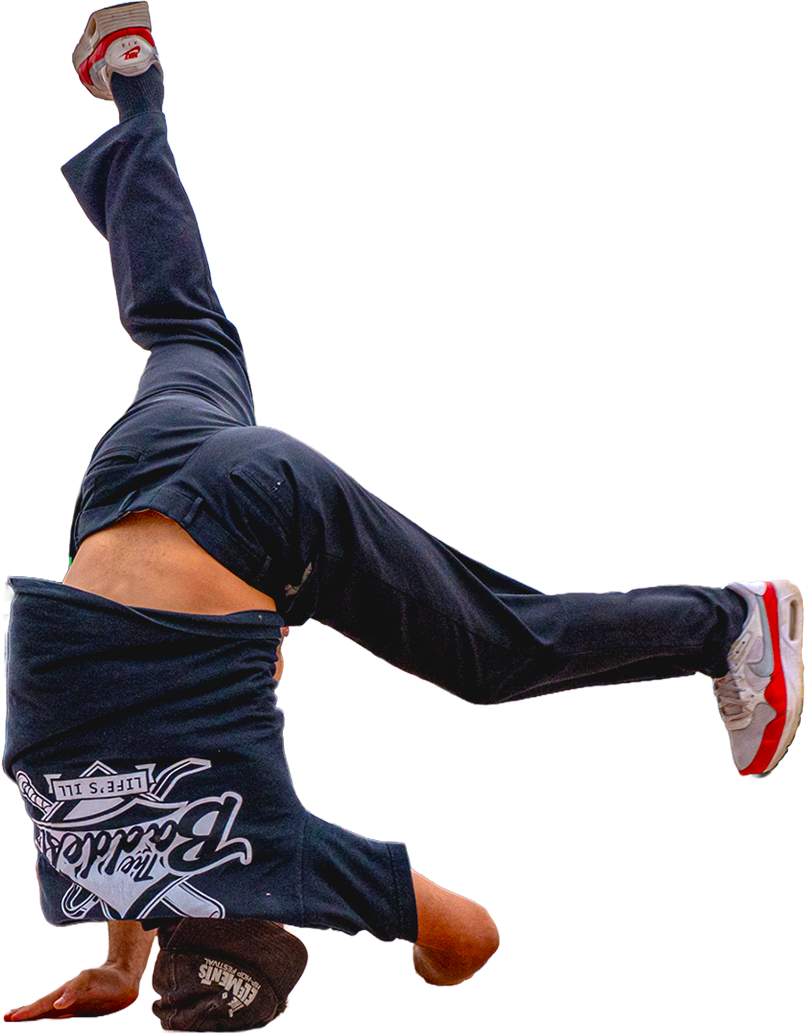 A b-boy frozen mid-power-move at the 4BQ breaking circle