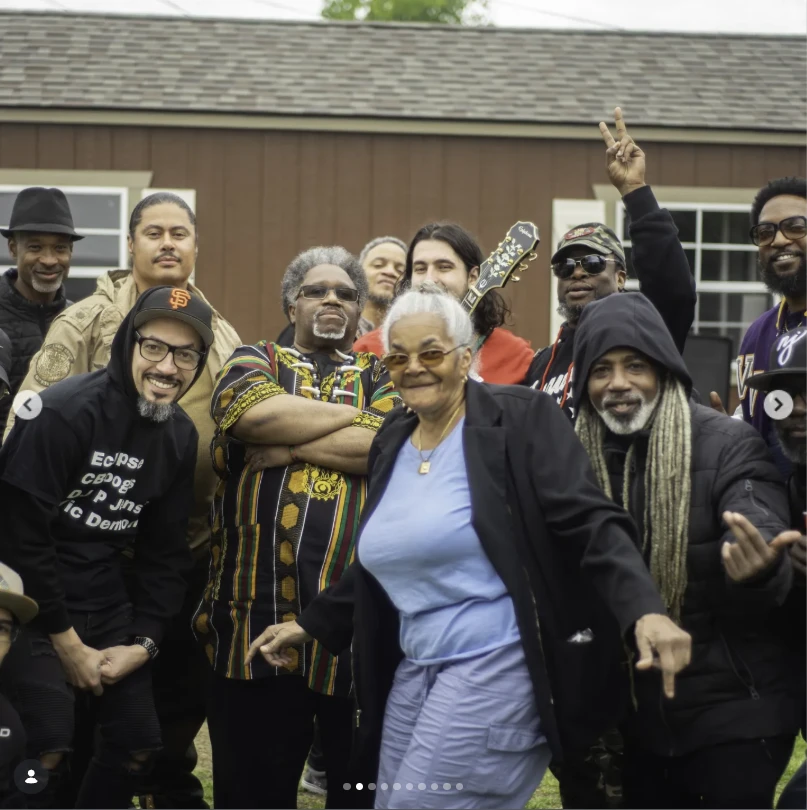 A group of friends and family gathered in front of a shed at Beats & Bars