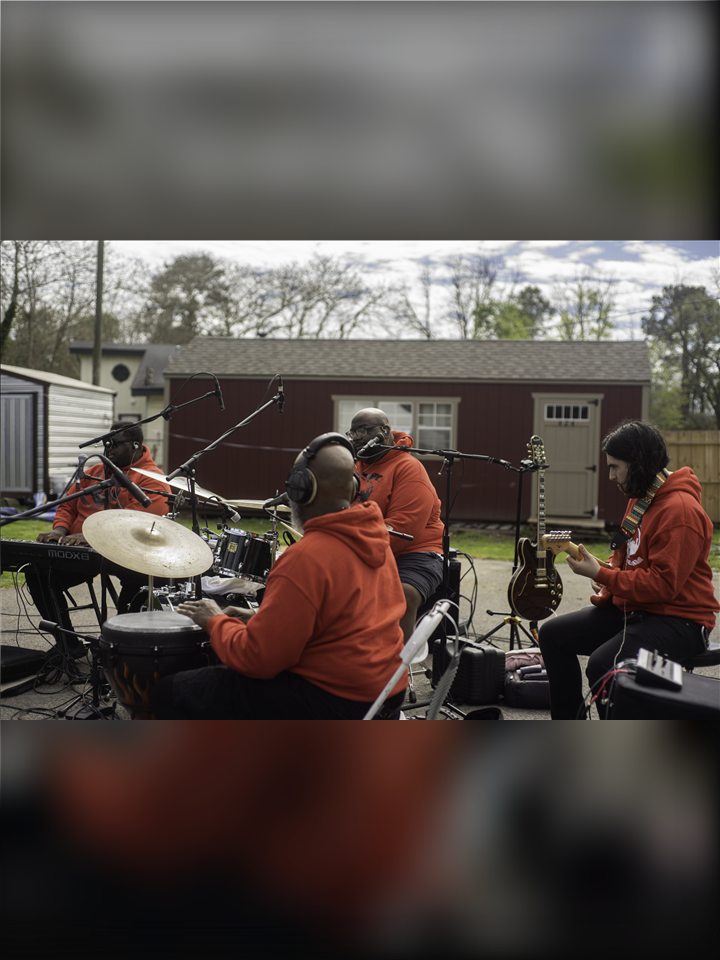 The live band set up in the yard: drums, percussion, keys and guitar, 2023.