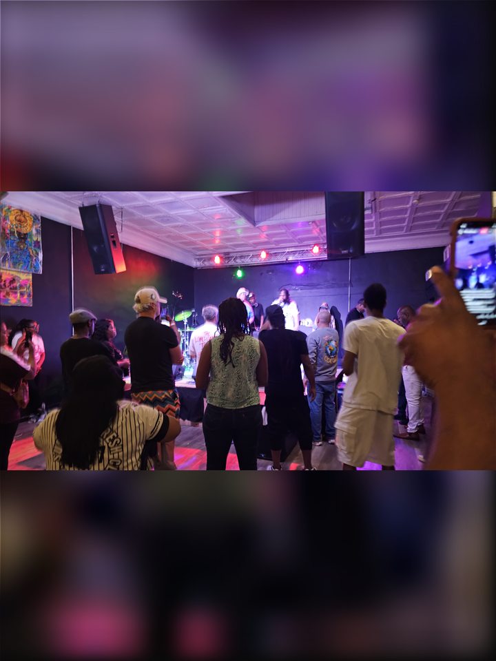 The crowd watches the stage from the dance floor, 2025.